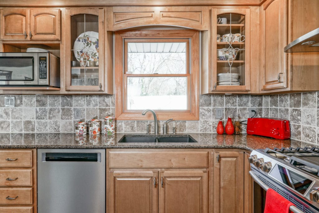 View of kitchen sink and glass cabinetry