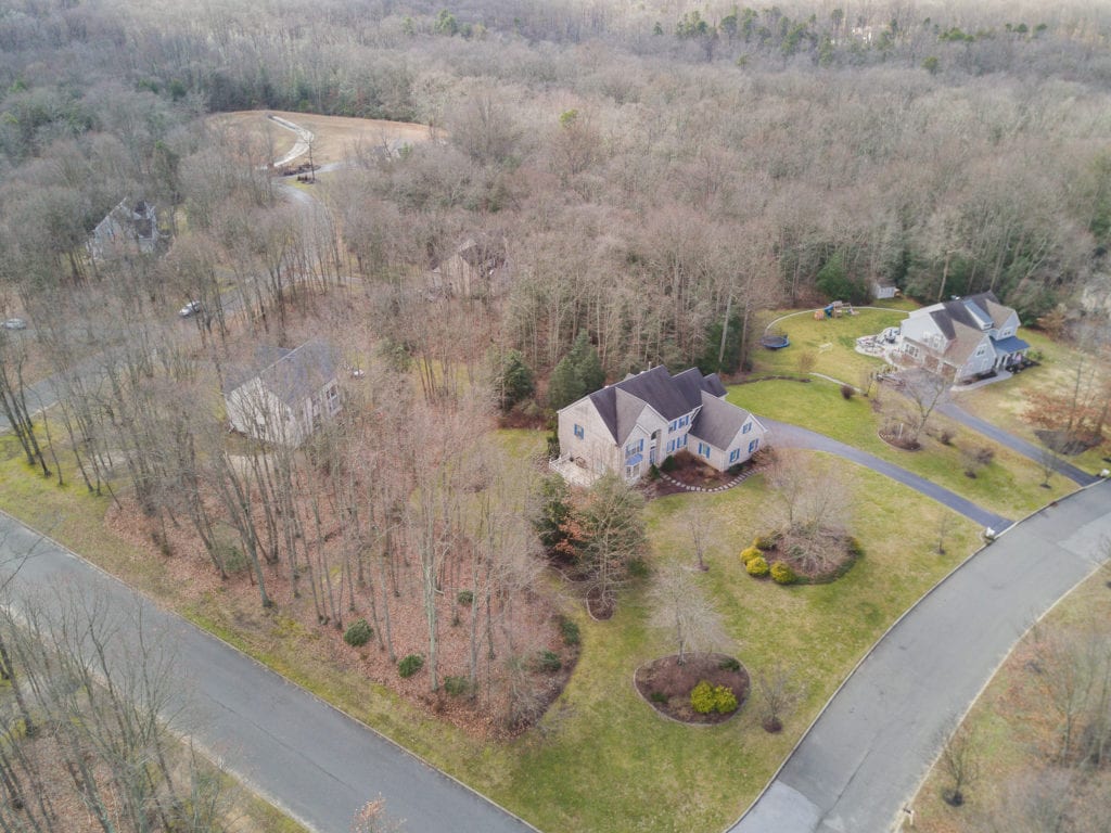 Aerial View showing the large corner lot and surrounding trees that give this home much coveted privacy.