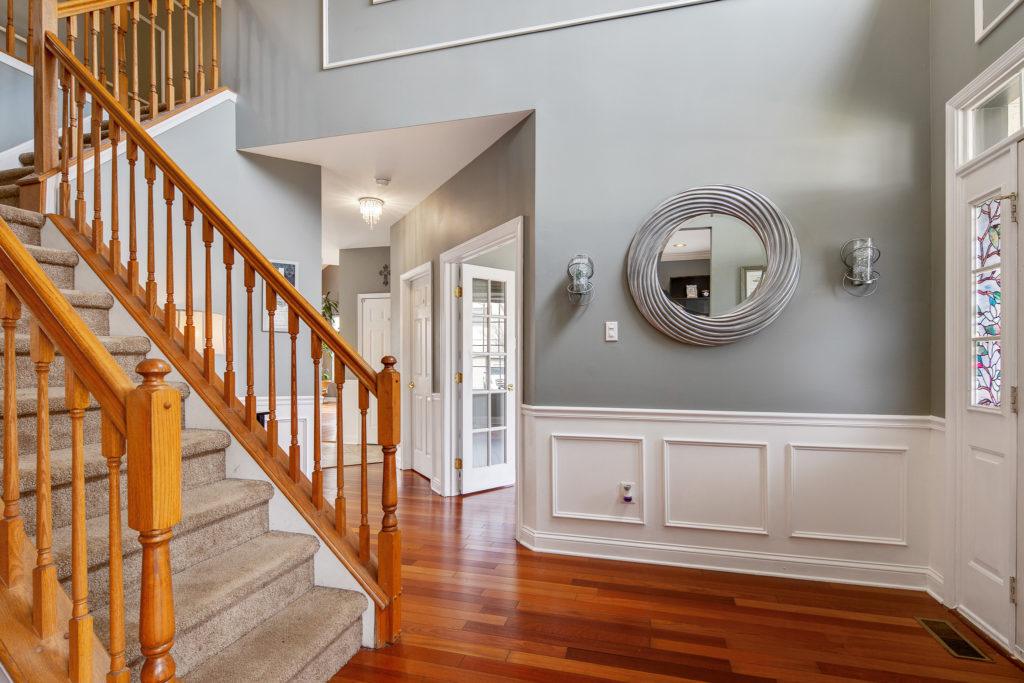 The two-story foyer with gorgeous hardwood floors and upscale trim work.
