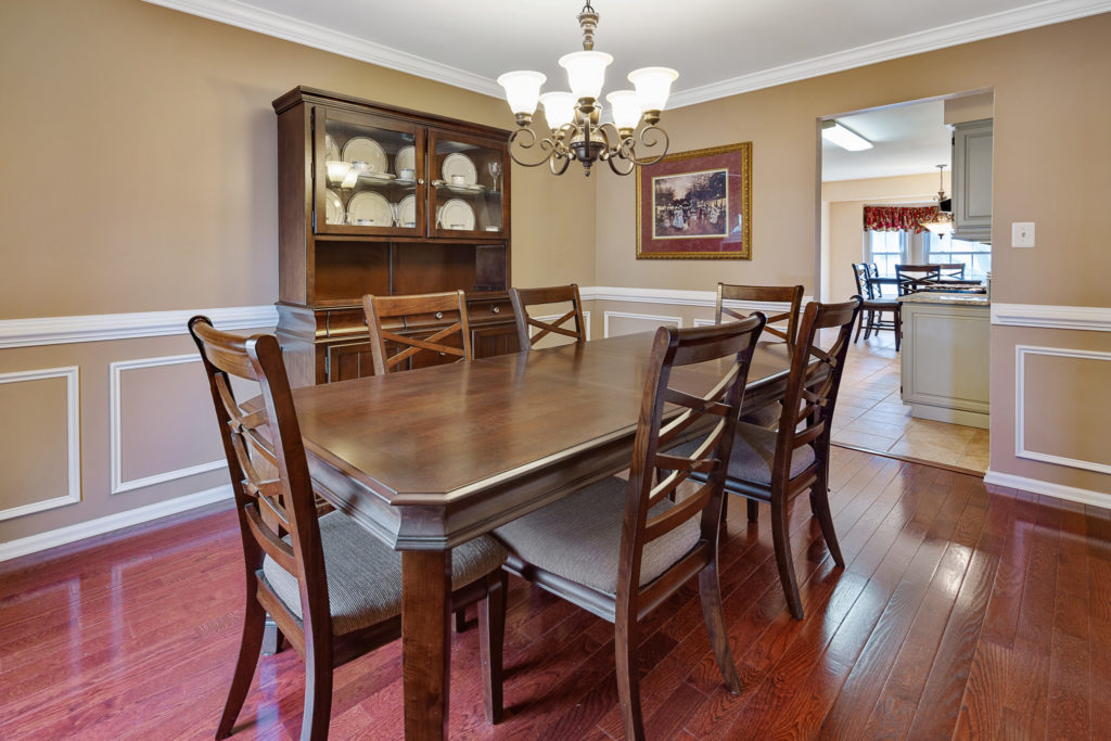 The formal dining room is dressed up with custom trim work