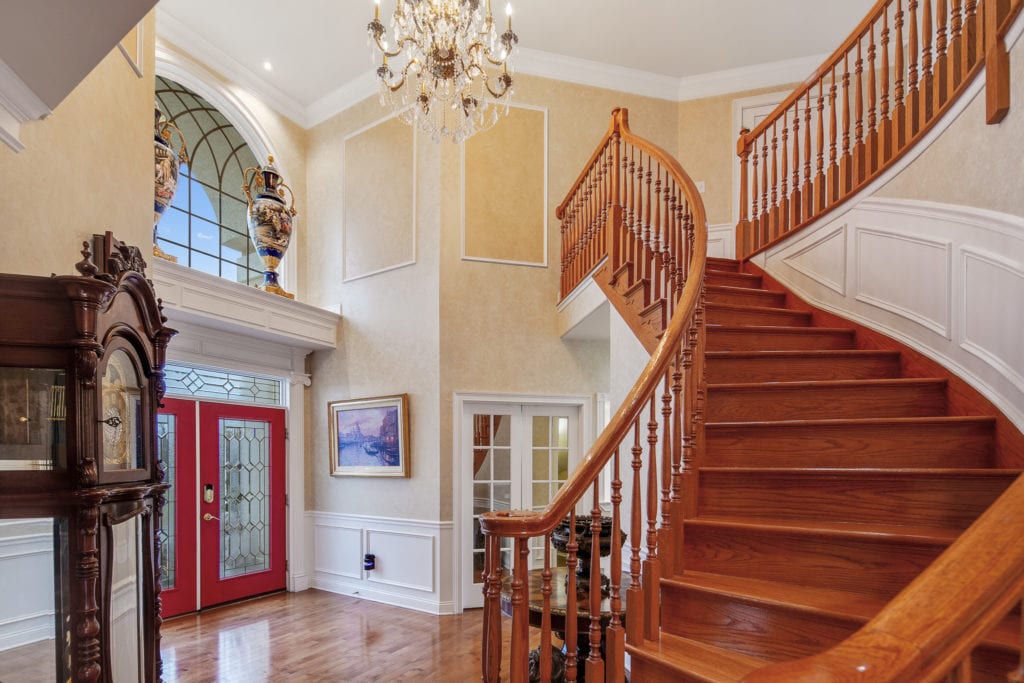 The foyer with grand oak staircase.