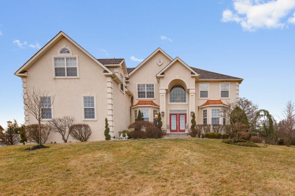 Front of 53 Messina showing grand chandelier window and double door entrance.