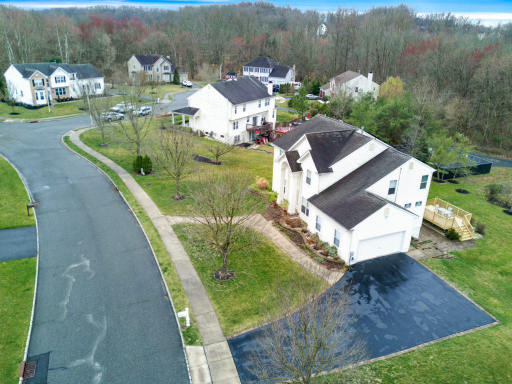 Aerial view showing garage and driveway