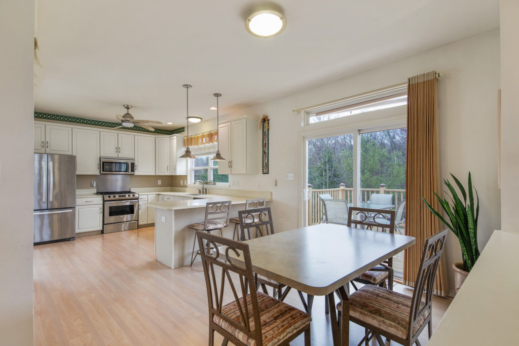 Kitchen has a sliding glass door to the deck.