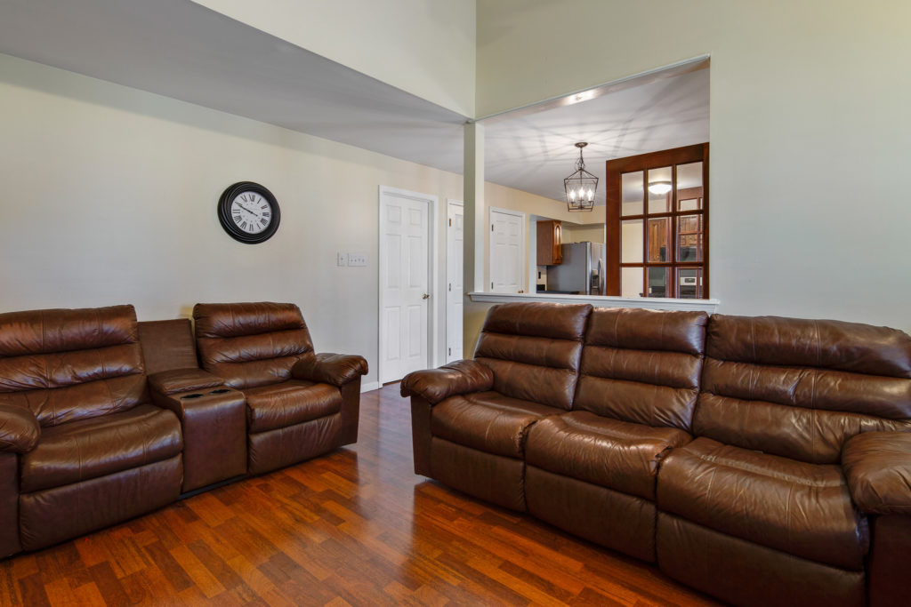 Family room with Vaulted Ceilings and fireplace with mantle 49 Woodduck Drive