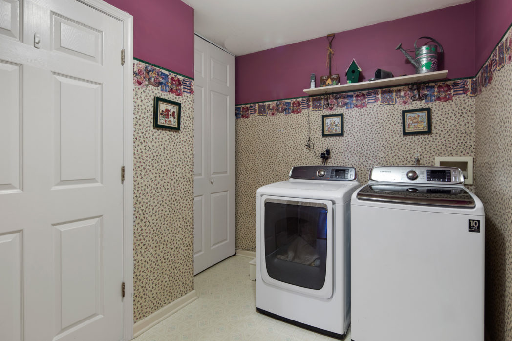Laundry room has wallpaper